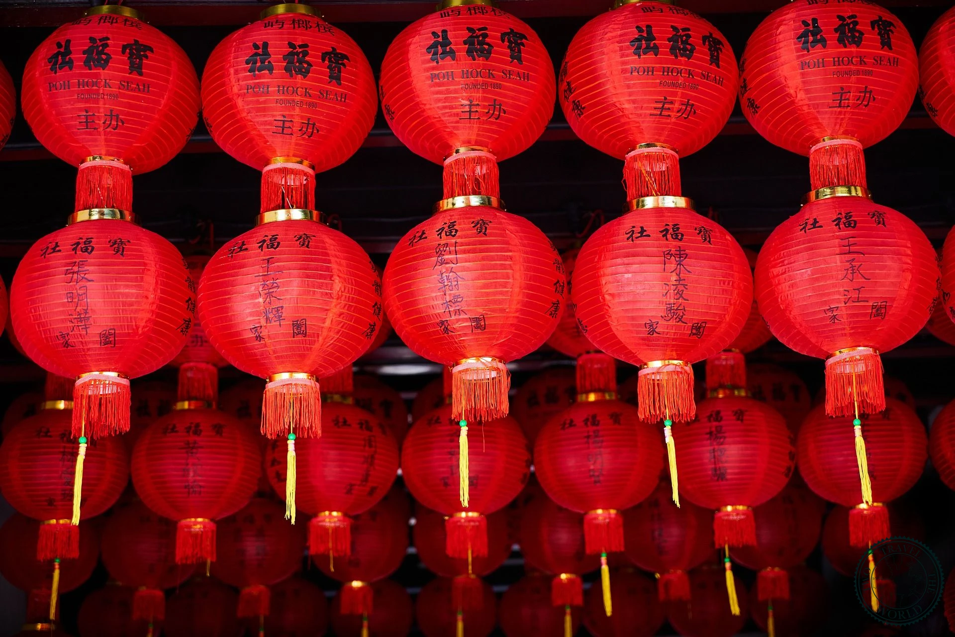 Rows of traditional red Chinese lanterns with golden tassels and calligraphy