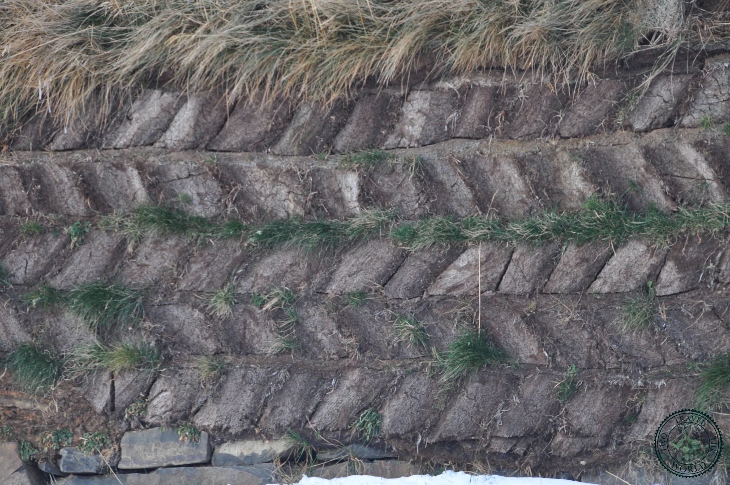 Close-up of the herringbone turf wall construction on the reconstructed longhouse