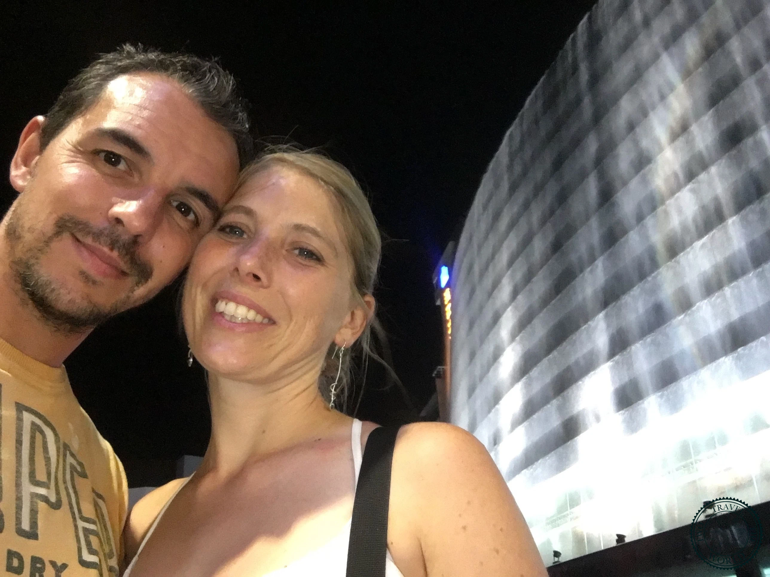 Illuminated waterfall cascading down the facade of Lijiang Waterfall Hotel at night
