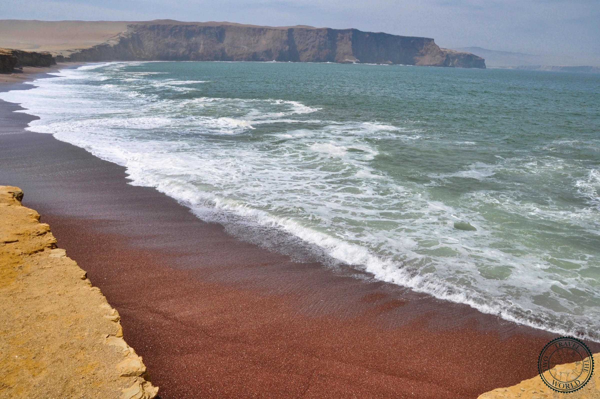 Playa Roja - Peru's famous red beach with distinctive reddish sand against blue ocean waters