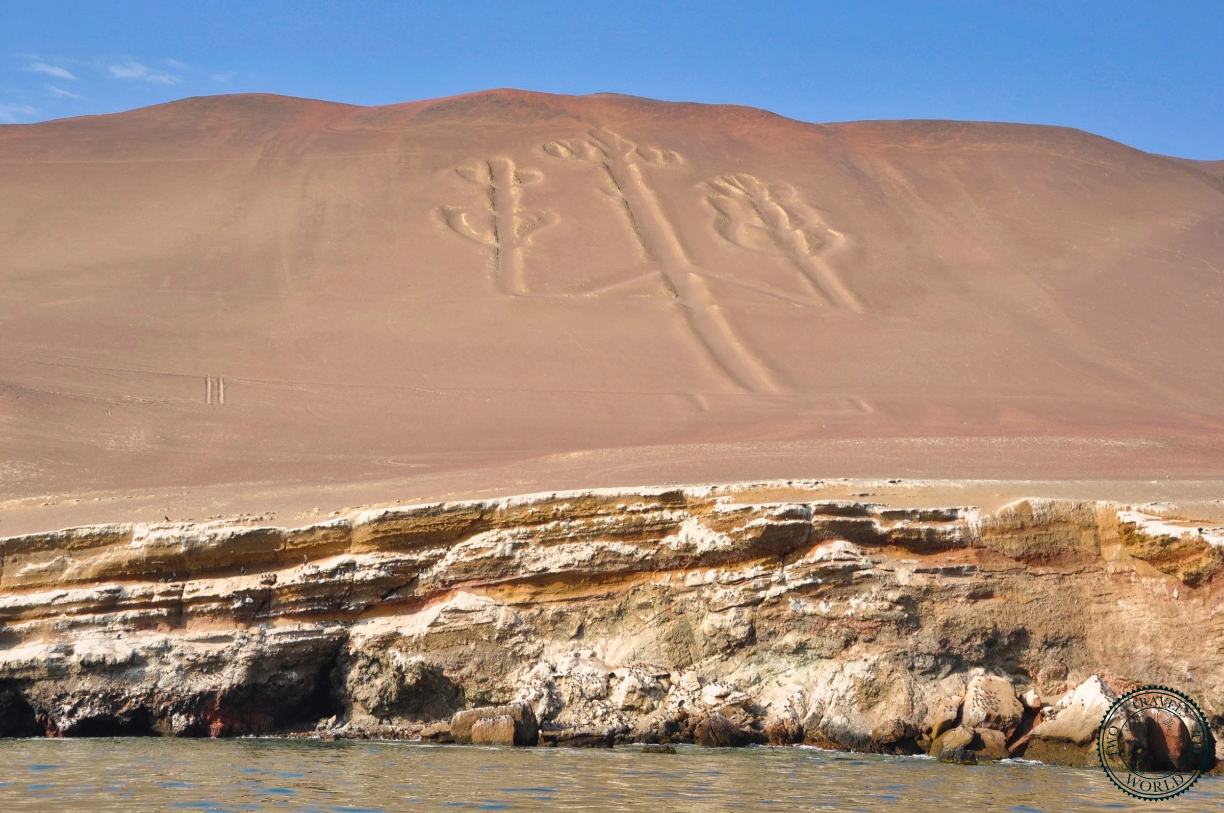 El Candelabro - massive pre-Inca geoglyph carved into coastal cliff visible from the ocean near Paracas