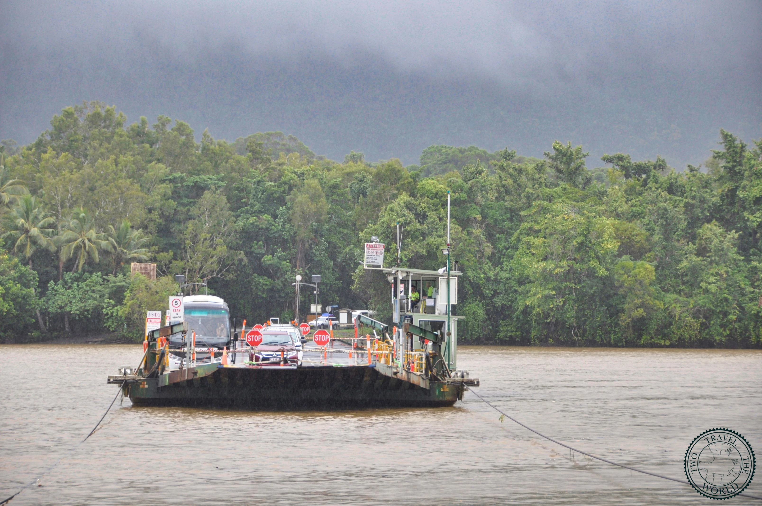 Swollen Mossman River with warning signs about dangerous swimming conditions after heavy rainfall