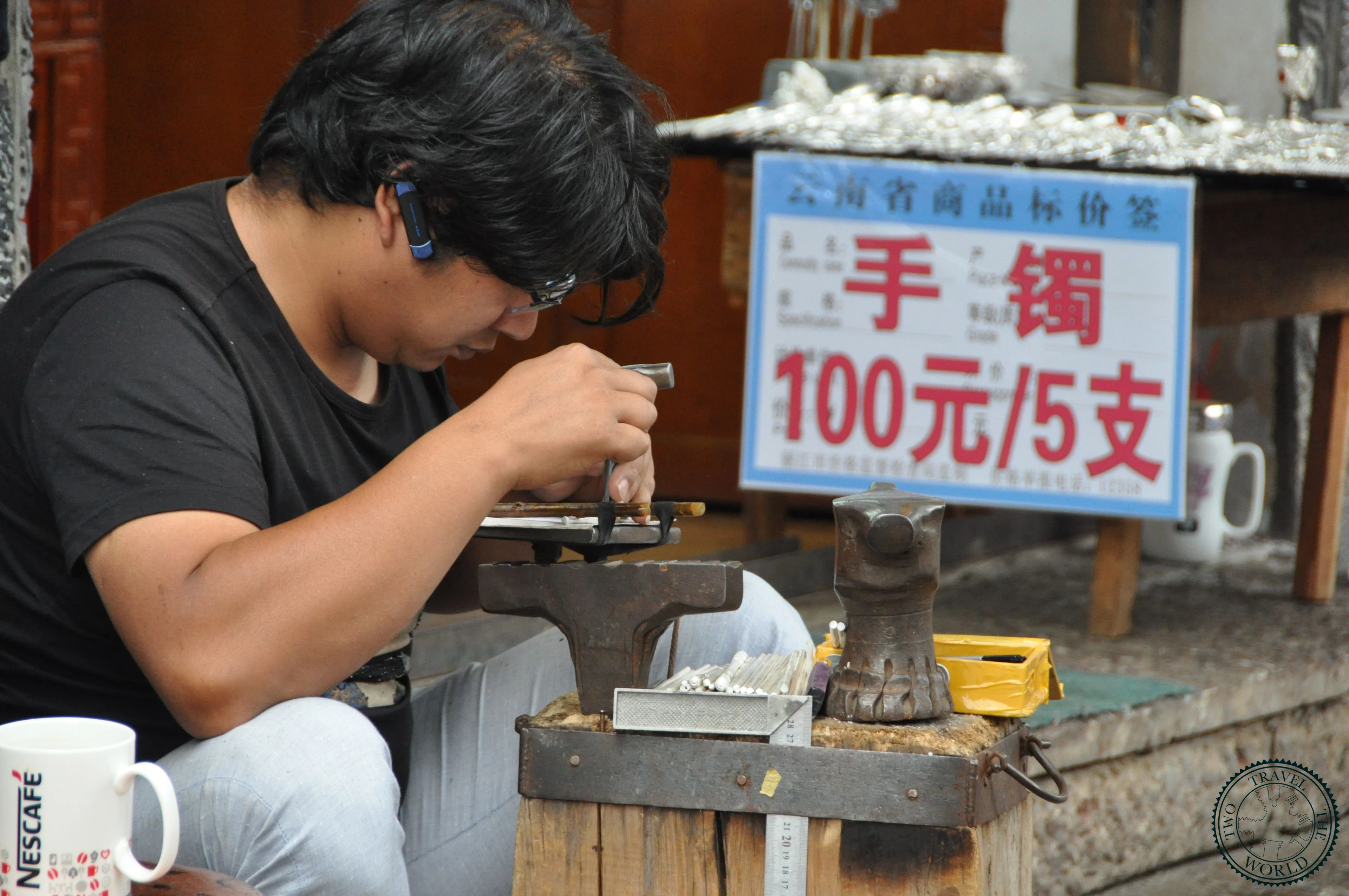 Traditional wooden architecture in Shuhe Old Town with locals browsing shops