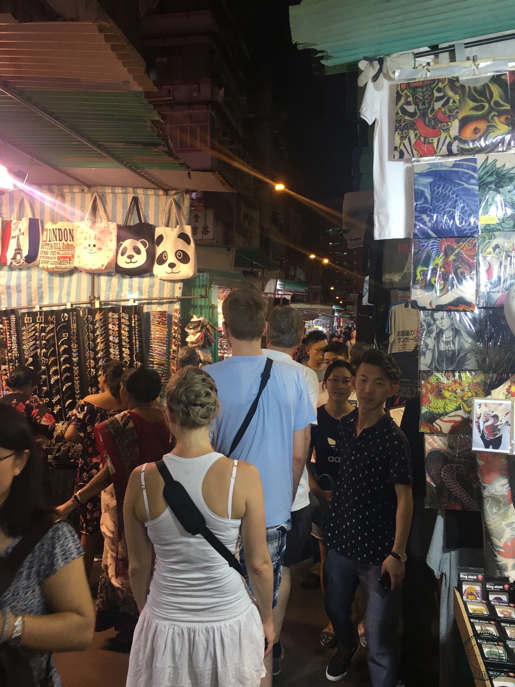 Bustling Temple Street Night Market with street vendors and neon lights