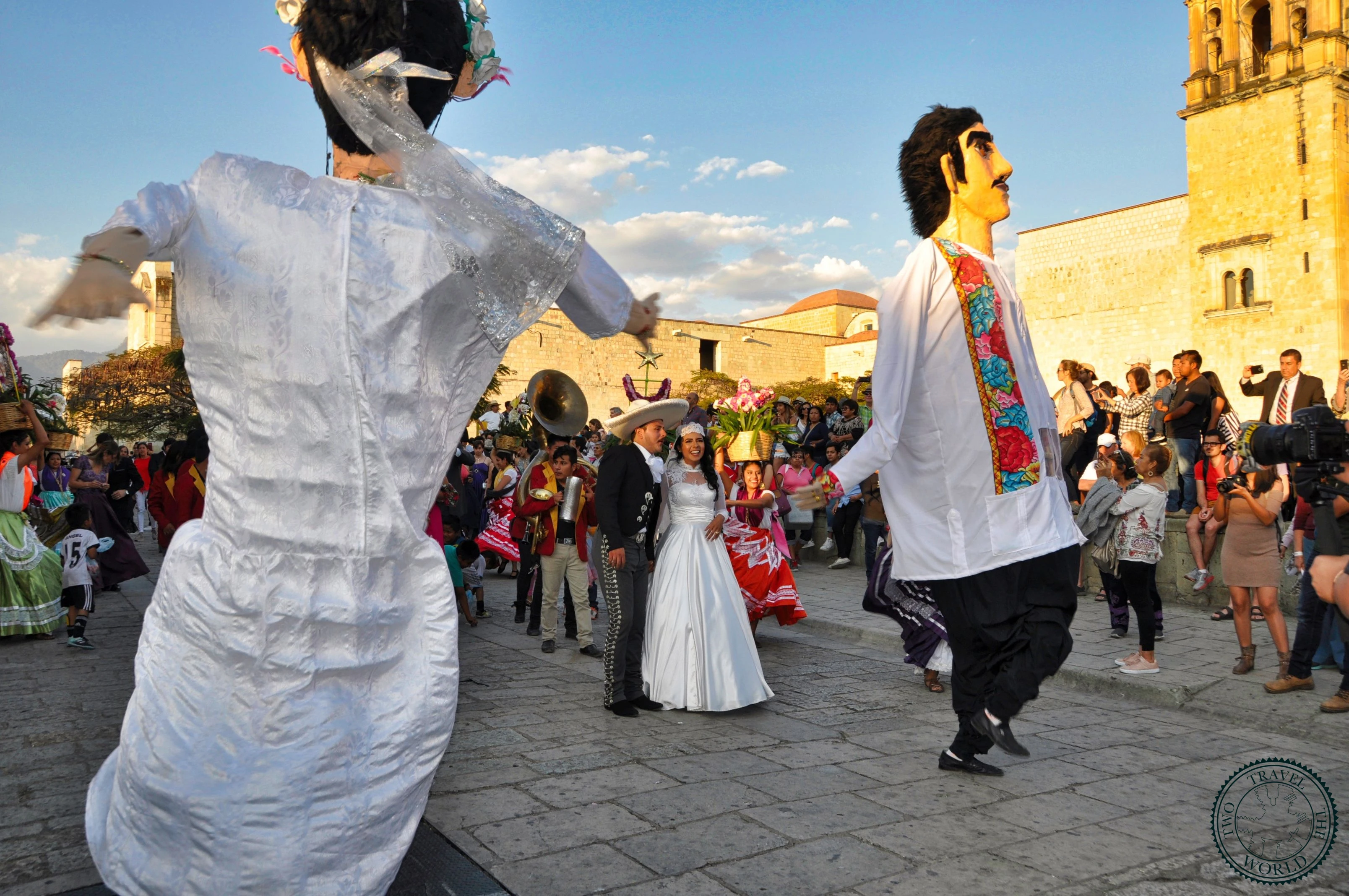 Elaborate Mexican wedding celebration outside Santo Domingo church in Oaxaca with colorful traditional decorations
